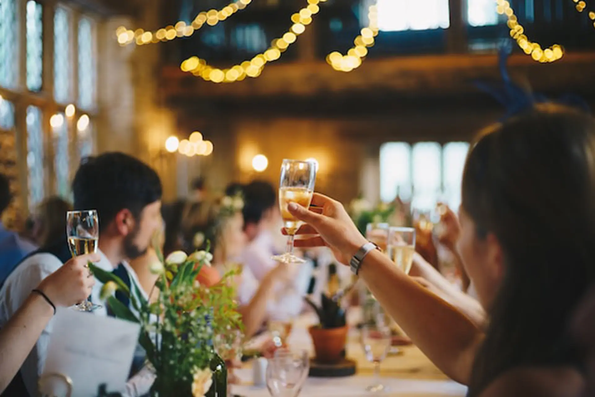 people holding champagne glasses celebrating together at a party