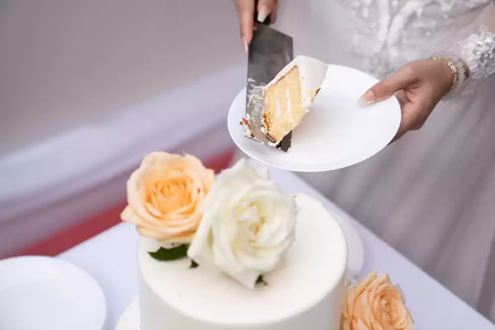 A bride with a slice of wedding cake
